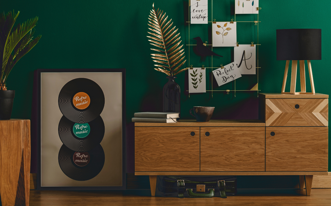 Retro photo with old records framed and sideboard with ornaments books and a lamp and old suitcase beneath the sideboard