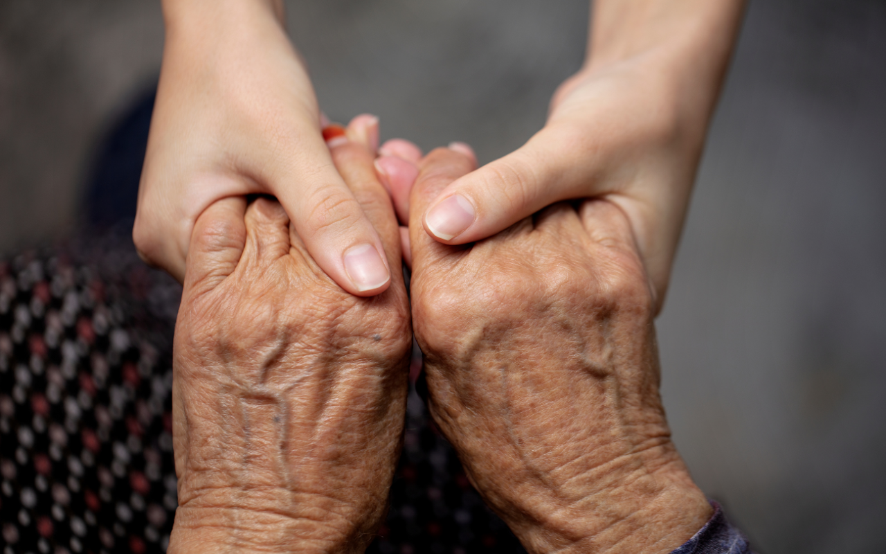 Young and older hands holding each other