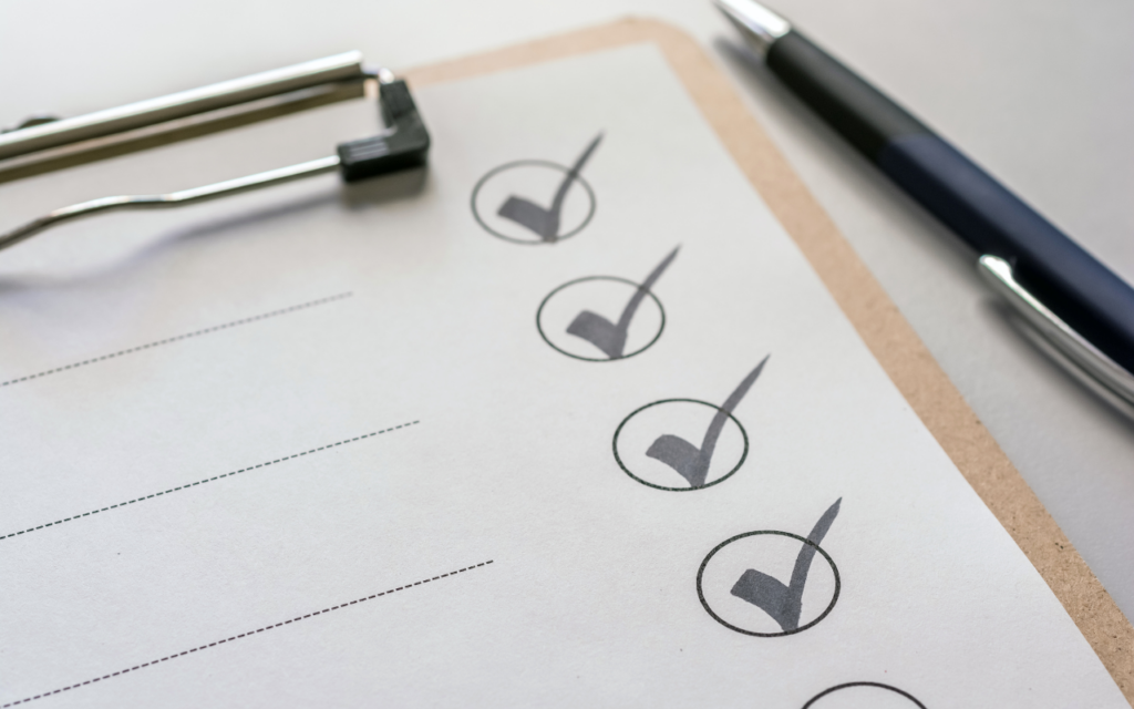 Paper checklist on a clipboard with pen on the right