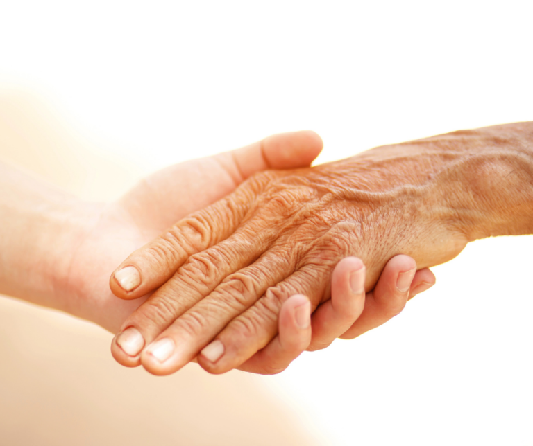 An old hand laying in a young hand