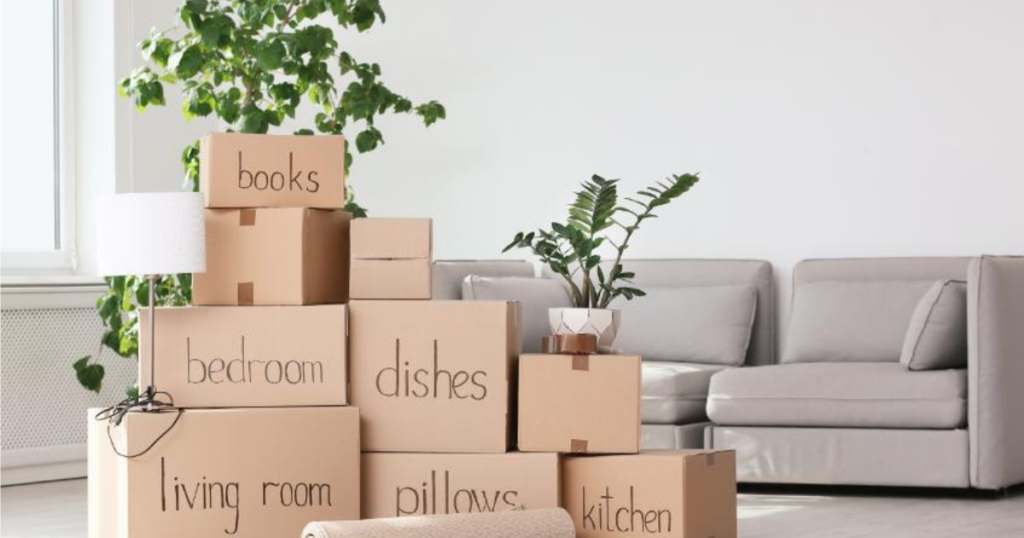 SM Blog Post Photo - 18 Aug 2026 - Moving boxes stacked with couch - What Happens on Moving Day A Step-by-Step Guide for Seniors and Their Families (3)