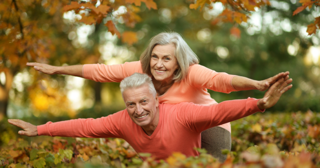 Senior couple making a flying motion with their hands